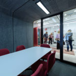 Framery-Smart-Office-Acoustic-Four-Person-Meeting-Pod-with-Red-Chairs-and-Conference-Table