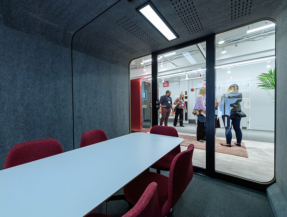 Framery-Smart-Office-Acoustic-Four-Person-Meeting-Pod-with-Red-Chairs-and-Conference-Table